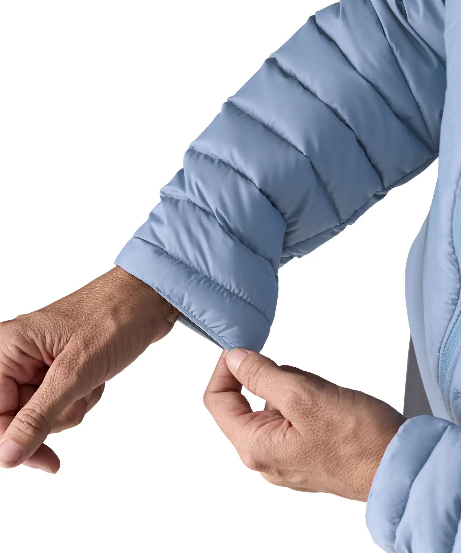 Woman wearing the Patagonia down insulated sweater hoody in barnacle blue showing close up of cuff trim