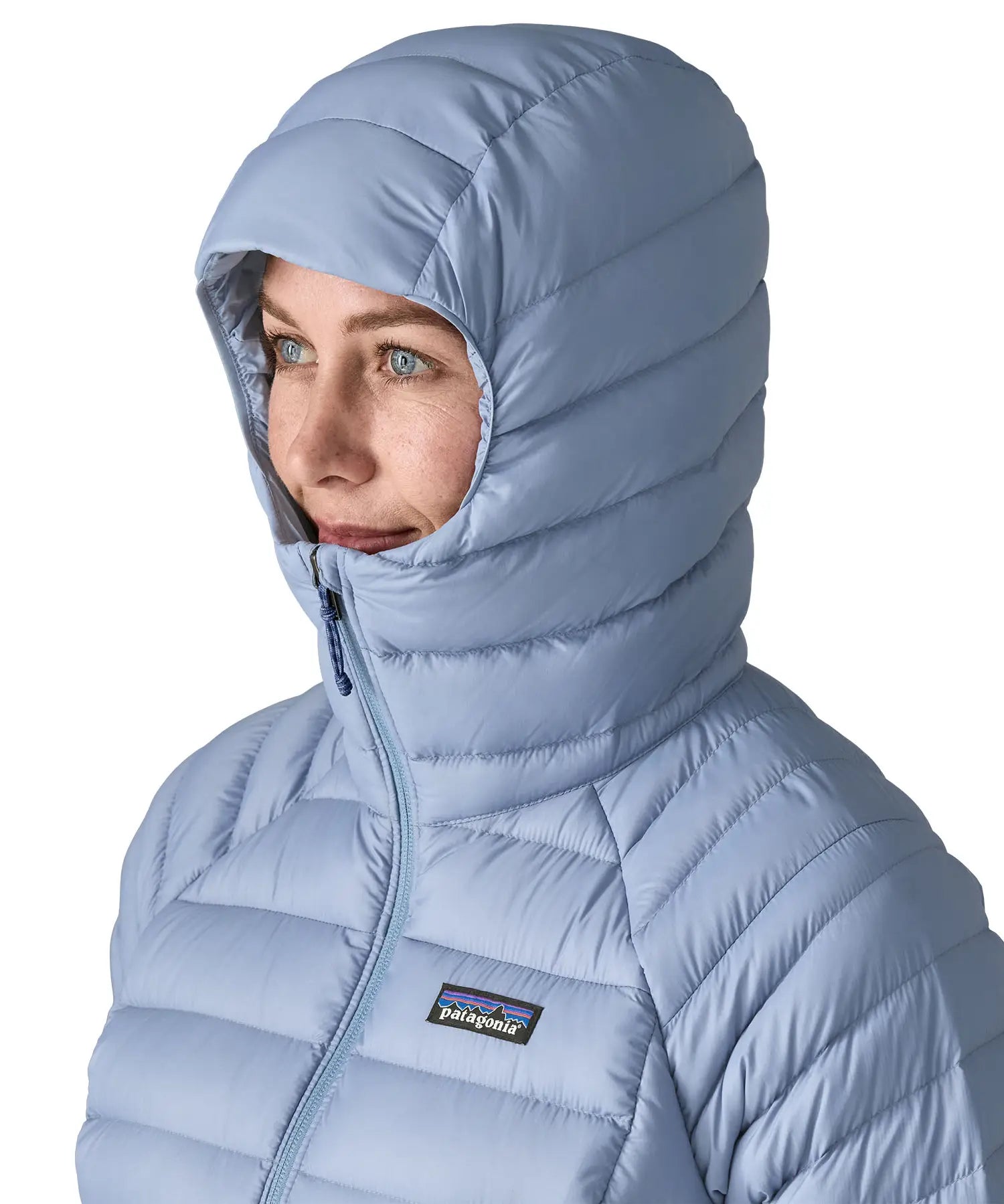 Woman wearing the Patagonia down insulated sweater hoody in barnacle blue showing close up of snug fit hood