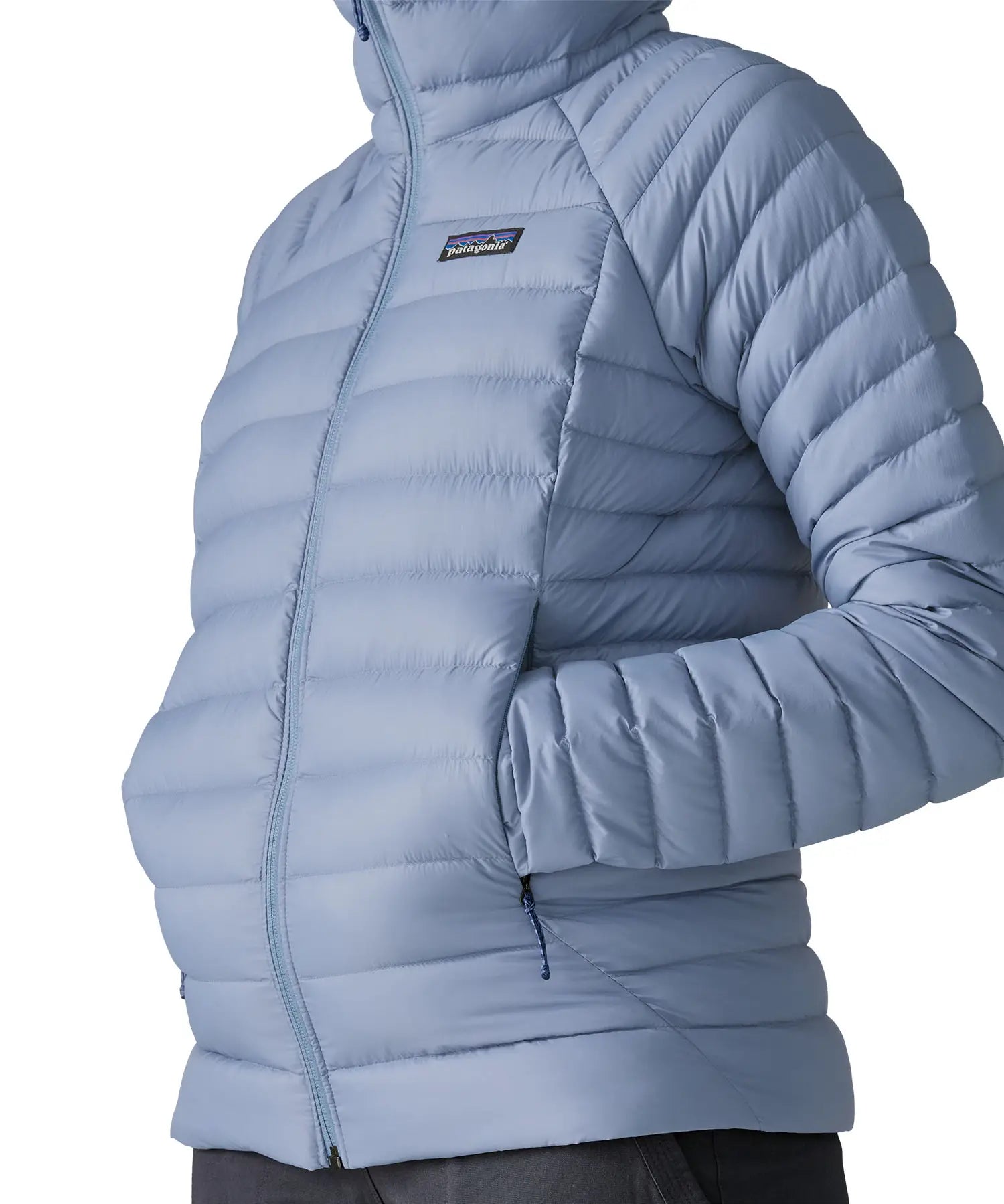 Woman wearing the Patagonia down insulated sweater hoody in barnacle blue showing close up of the side pocket