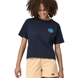 Woman wearing Patagonia women's unity Fitz roy responsibili short sleeve tshirt in navy  blue. Top has a boxy fit