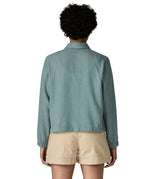 Back of woman wearing Patagonia women's lightweight jacket in blue. Jacket has a boxy fit and sits at the hips