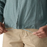 Close up of woman wearing Patagonia women's lightweight jacket in blue showing inside hem tie