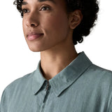 Close up of woman wearing Patagonia women's lightweight jacket in blue showing collar and front zip detail