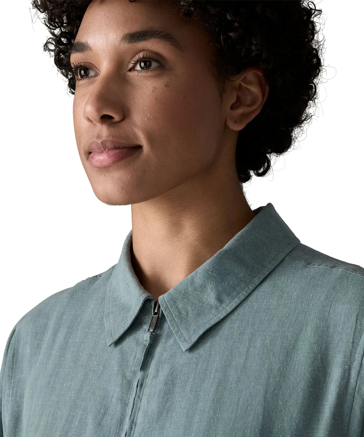 Close up of woman wearing Patagonia women's lightweight jacket in blue showing collar and front zip detail