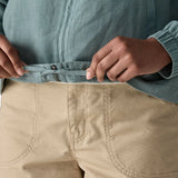 Close up of woman wearing Patagonia women's lightweight jacket in blue showing hands on the inside hem tie