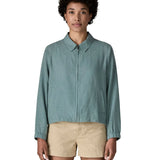 Woman wearing Patagonia women's lightweight jacket in blue. Features a full length front zip, collar and side pockets