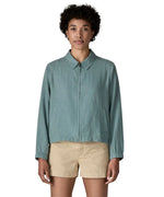 Woman wearing Patagonia women's lightweight jacket in blue. Features a full length front zip, collar and side pockets