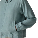 Close up of woman wearing Patagonia women's lightweight jacket in blue showing hands inside side pocket
