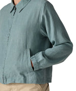 Close up of woman wearing Patagonia women's lightweight jacket in blue showing hands inside side pocket