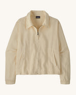 Patagonia women's lightweight jacket with collar in natural cream colour. Features a full length front zip and side pockets