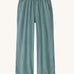 Patagonia women's garden island light weight pants in sage green. Shows 2 front pockets and a elasticated waist band