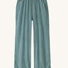 Patagonia women's garden island light weight pants in sage green. Shows 2 front pockets and a elasticated waist band