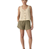 Woman wearing Patagonia women's reversible garden island vest top in cream. Vest top has a relaxed fit and sits at the hips