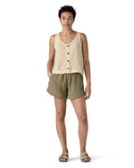 Woman wearing Patagonia women's reversible garden island vest top in cream. Vest top has a relaxed fit and sits at the hips