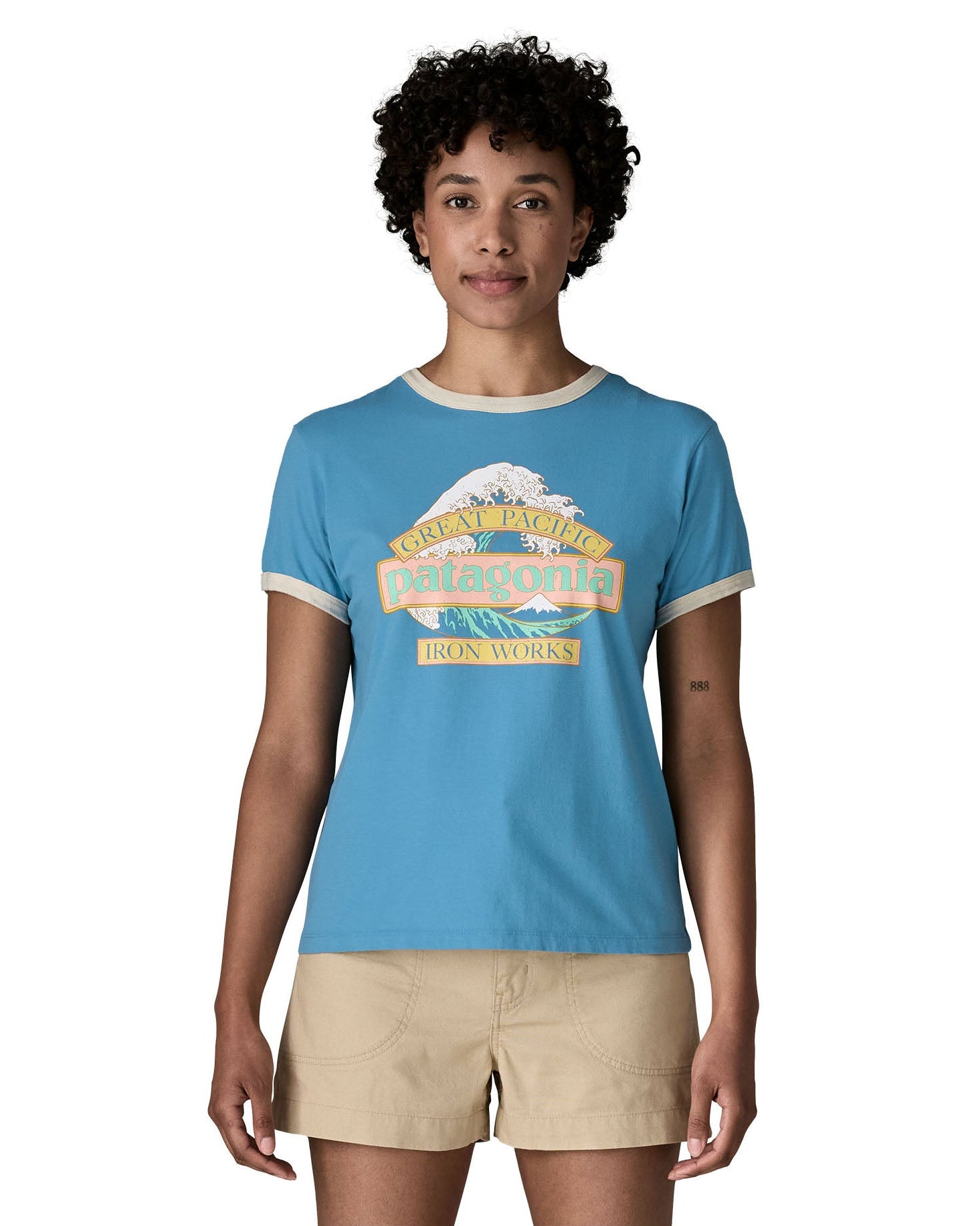 Woman wearing Patagonia women's great waves ringer t-shirt in light blue with a wave logo on the upper body.