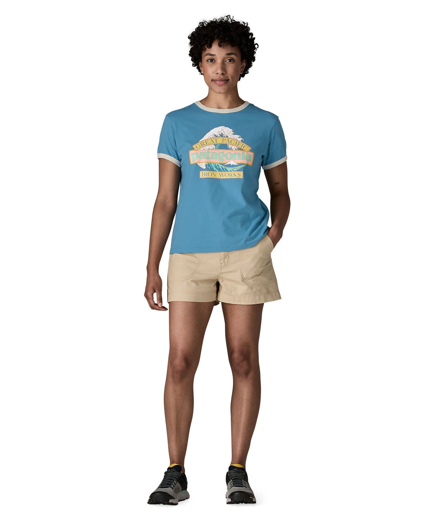 Woman wearing Patagonia women's great waves ringer t-shirt in light blue with a wave logo on the upper body. T-shirt has a regular fit