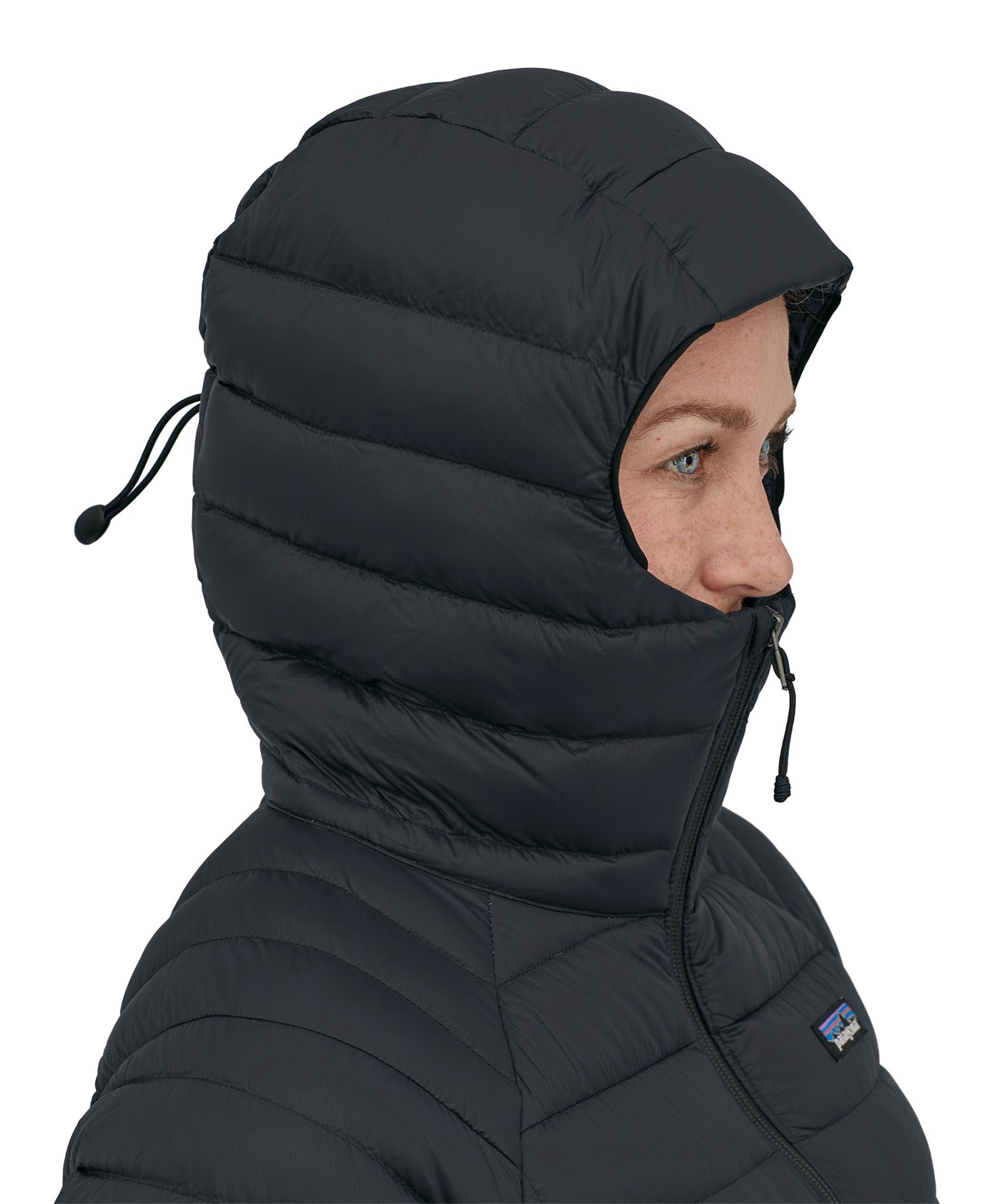 The hood up on the Patagonia Women's Down Sweater Hoody, showing how far it zips up to keep the chin and face warm