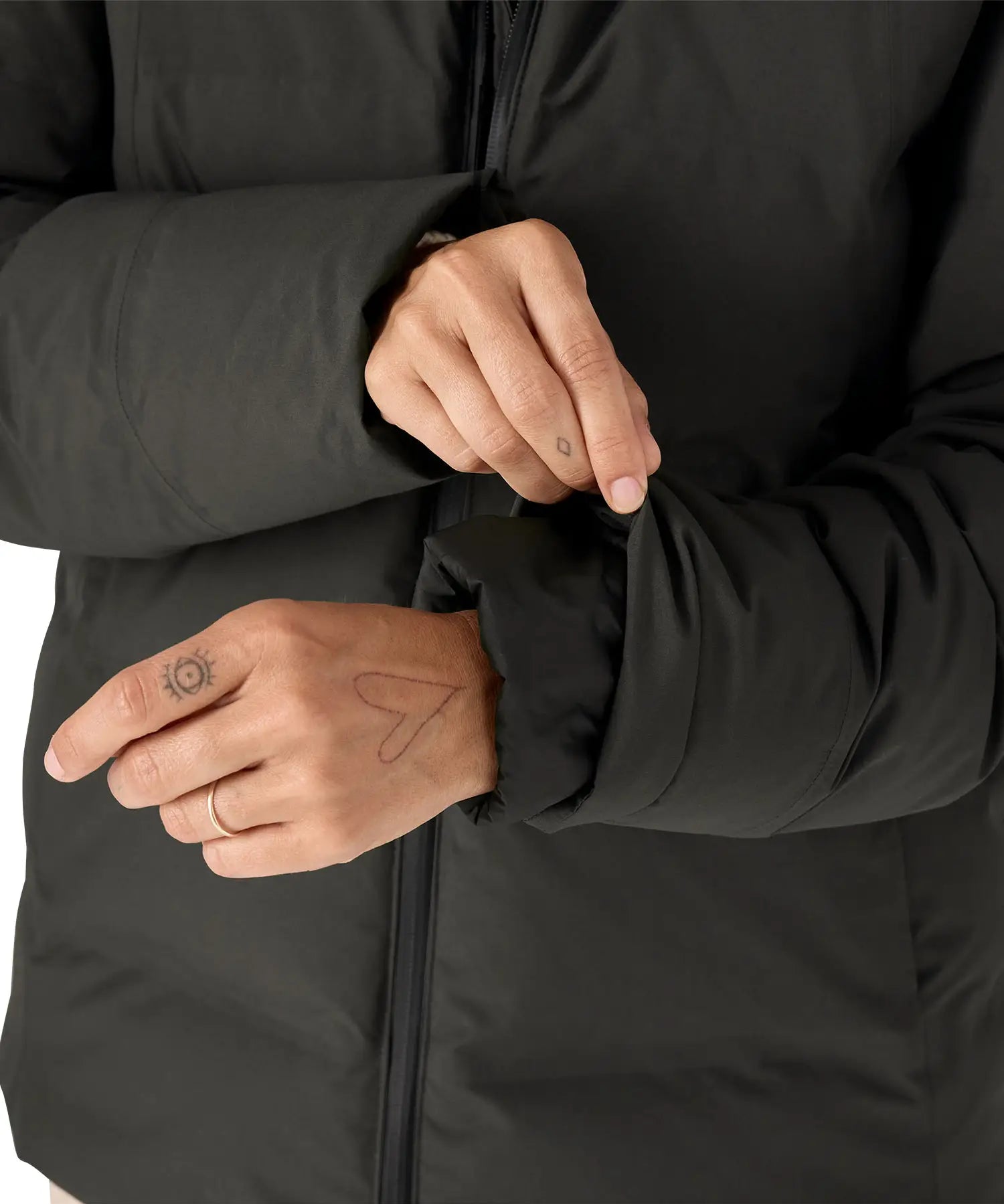 Woman pulling on the cuff on the Patagonia's waterproof Jackson glacier jacket in black showing the inner lining