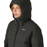 Hood on the Patagonia's waterproof women's Jackson glacier jacket in black  over the head