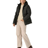 Woman wearing Patagonia's black waterproof Jackson glacier hooded jacket. Jacket has a relaxed fit and sits at the hips