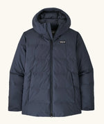 Patagonia waterproof women's Jackson glacier hooded jacket in dark blue showing front zip and side pockets