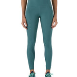 A model wearing the Patagonia women's leggings in wetland blue available at Babipur showing the front fit of the leggings