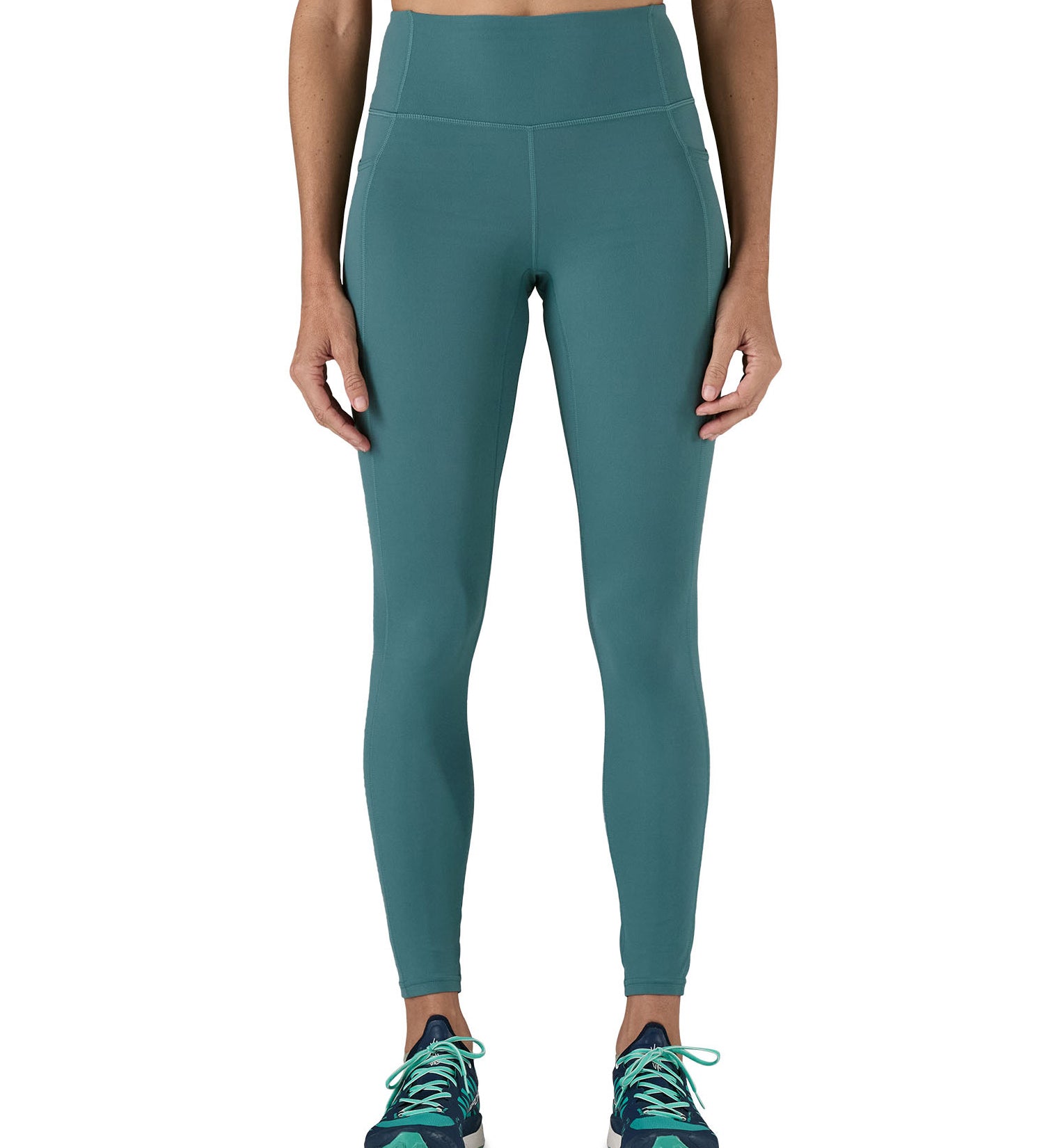 A model wearing the Patagonia women's leggings in wetland blue available at Babipur showing the front fit of the leggings