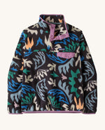 Patagonia women's synchilla snap t fleece in black with a retro abstract design. Shows a 1/4 length front popper up to the collar and a chest pocket