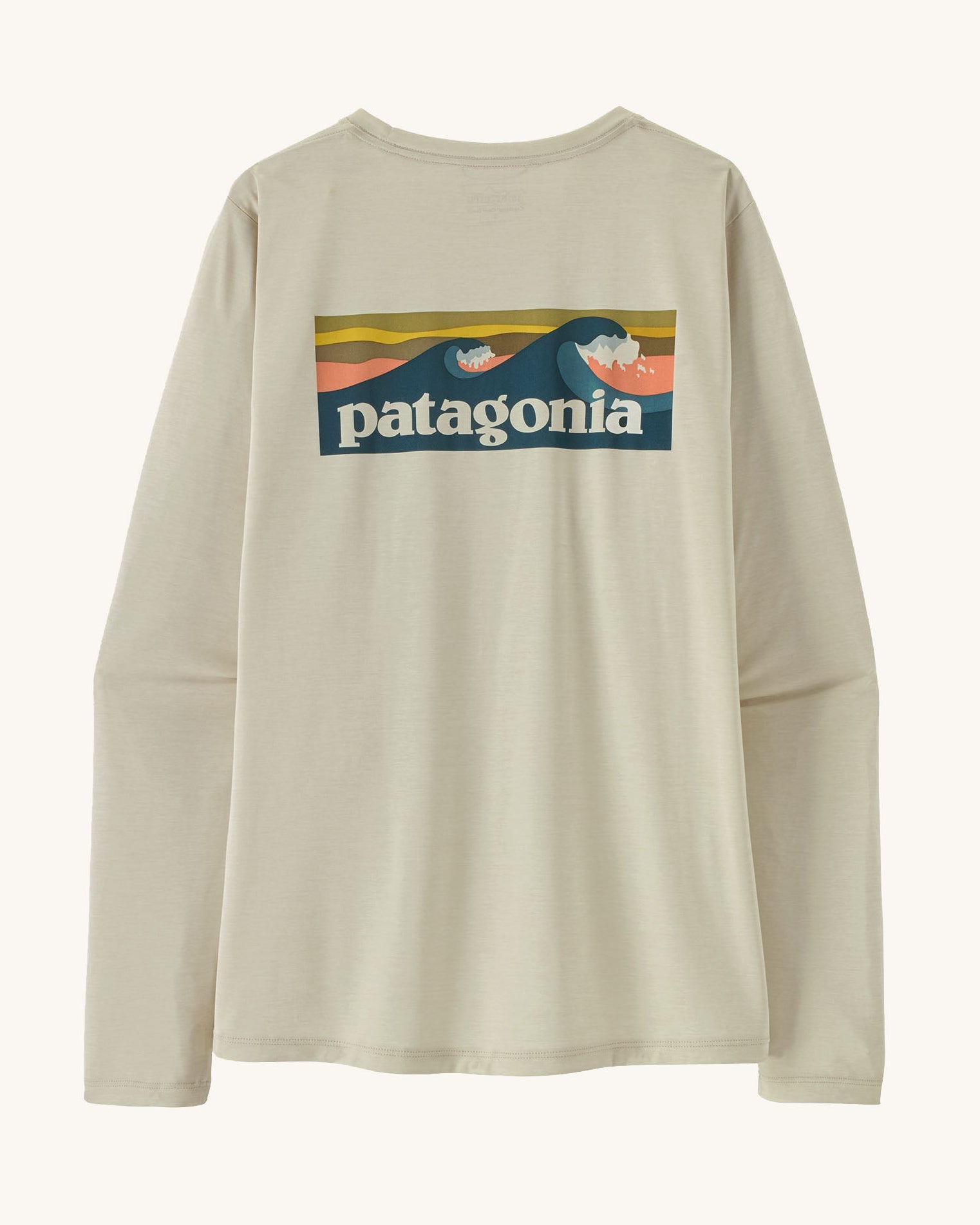 Patagonia women's long sleeve capilene cool t-shirt in cream with wave logo graphic on upper back