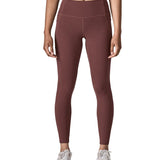 Woman wearing Patagonia's maipo stash leggings in dark red. Tights have a high rise fit 