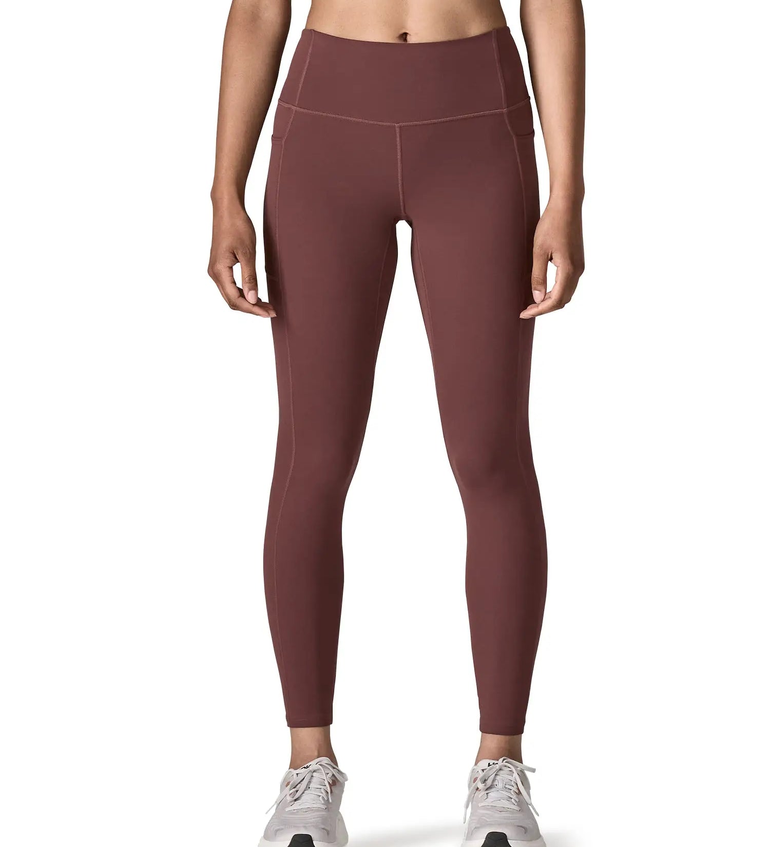 Woman wearing Patagonia's maipo stash leggings in dark red. Tights have a high rise fit 