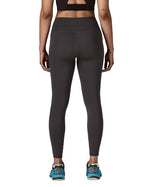 Back of woman wearing Patagonia's maipo stash black leggings. Tights have a high rise fit and 7/8 length
