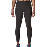 Woman wearing Patagonia's maipo stash black leggings. Tights have a high rise fit 