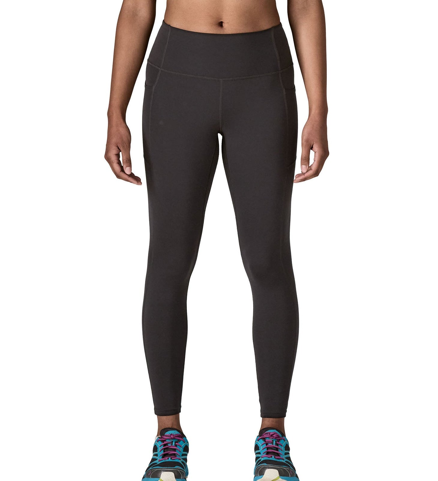 Woman wearing Patagonia's maipo stash black leggings. Tights have a high rise fit 