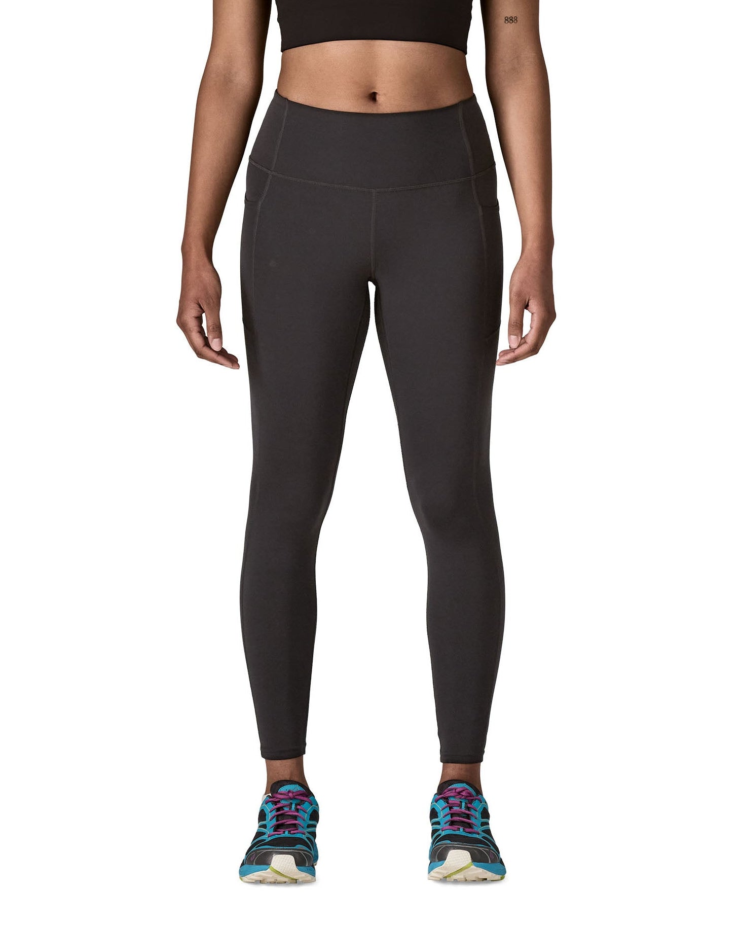Woman wearing Patagonia's maipo stash black leggings. Tights have a high rise fit 