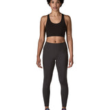 Woman wearing Patagonia's maipo stash black leggings with a black sports vest and trainers