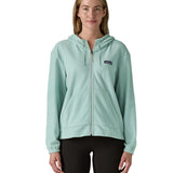 Woman wearing Patagonia's micro d hooded fleece in virtually blue. Fleece has a relaxed fit and sits at the hips
