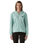 Woman wearing Patagonia's micro d hooded fleece in virtually blue. Fleece has a relaxed fit and sits at the hips