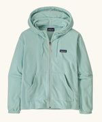 Patagonia women's micro d hooded fleece in pastel blue. Shows a full length front zip, pouch pockets and drawstring cord around the hood.