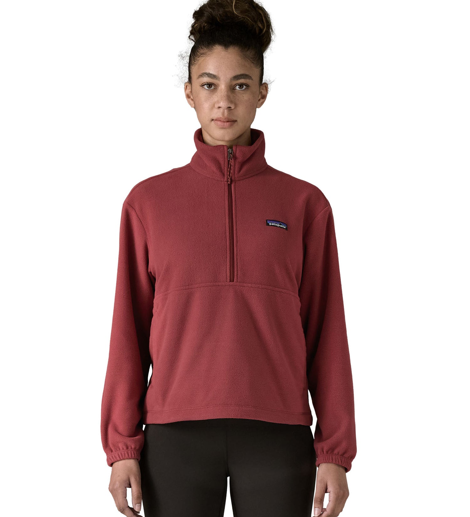 A model wearing the Patagonia women's micro d 1/2 zip fleece in sequoia red available at Babipur showing the front fit of the fleece