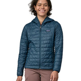Woman wearing the Patagonia nano puff hoody jacket in a lagom blue. 