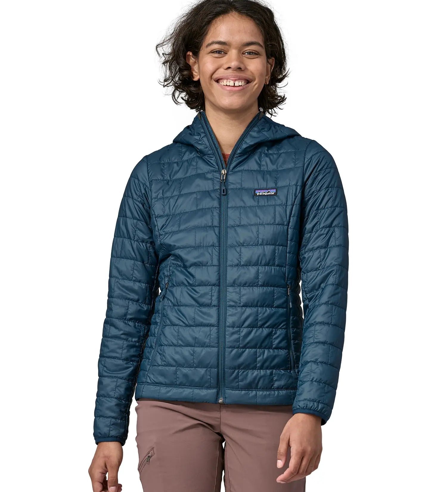 Woman wearing the Patagonia nano puff hoody jacket in a lagom blue. 