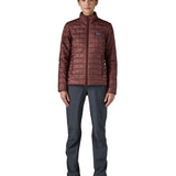 A female model wearing the Patagonia women's nano puff jacket in dark ruby 