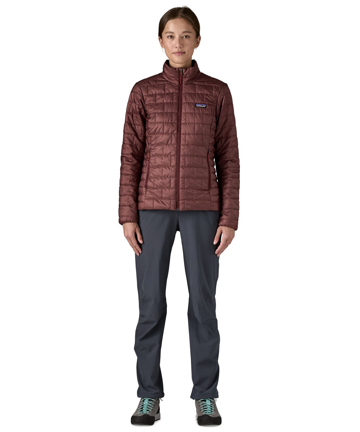 A female model wearing the Patagonia women's nano puff jacket in dark ruby 