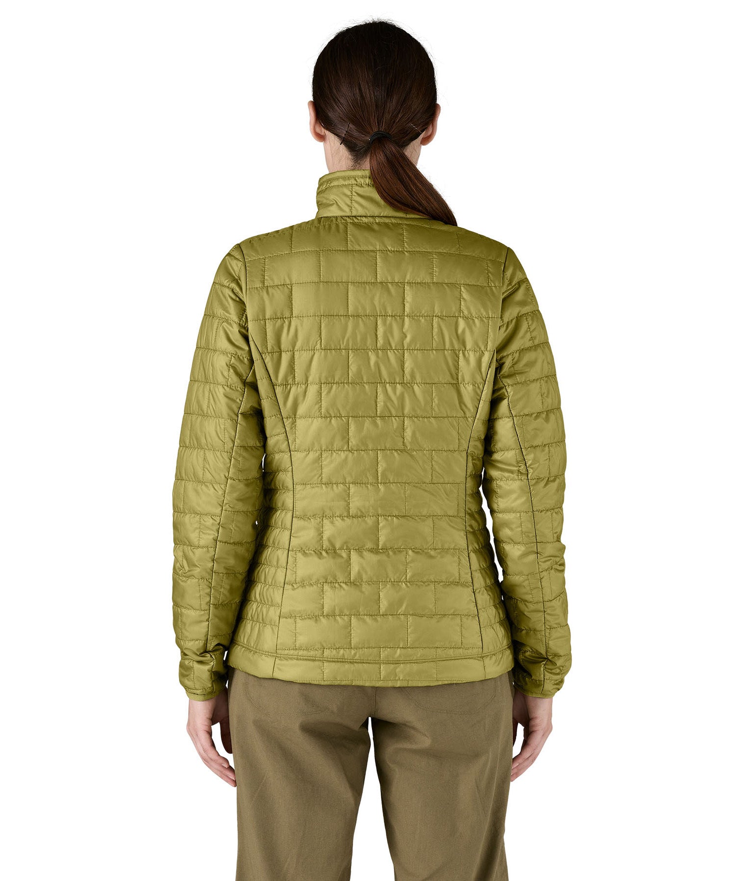 A female model wearing the Patagonia women's nano puff jacket in graze green showing the back fit of the jacket