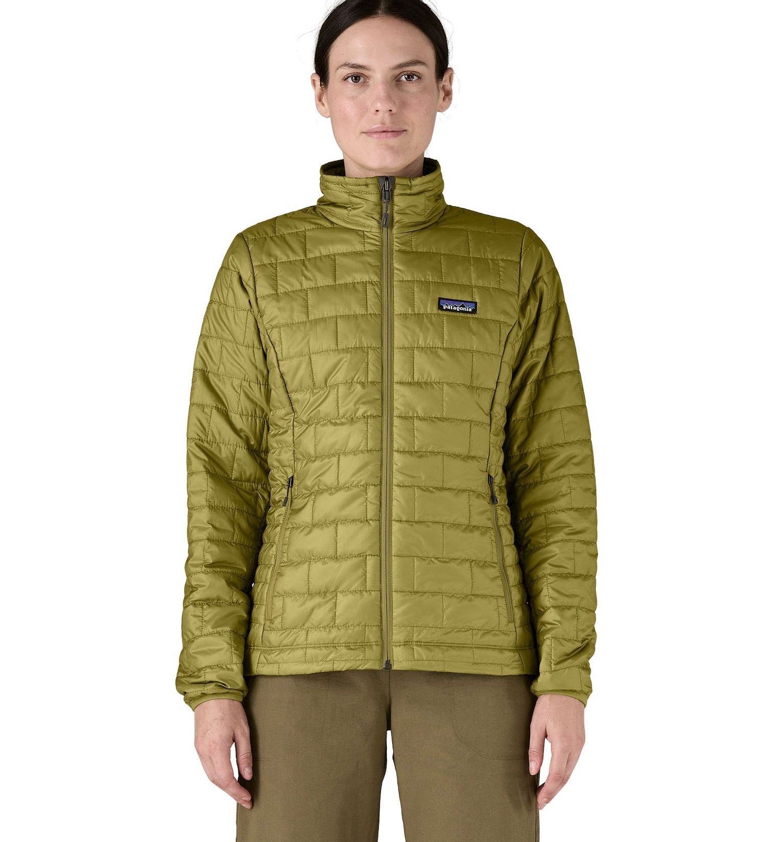 A female model wearing the Patagonia womens nano puff jacket in graze green showing the front fit of the jacket