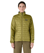 A female model wearing the Patagonia womens nano puff jacket in graze green showing the front fit of the jacket