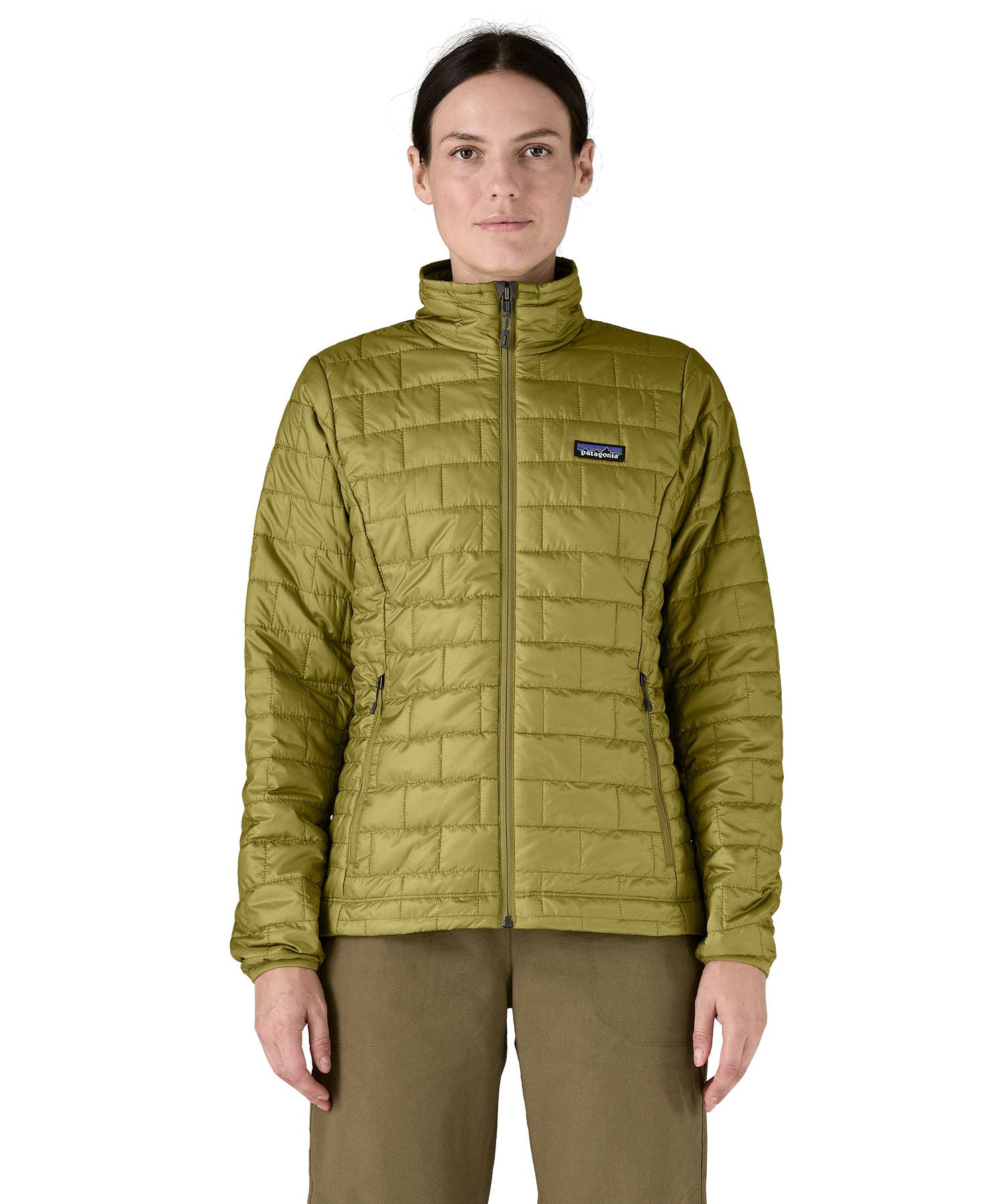 A female model wearing the Patagonia womens nano puff jacket in graze green showing the front fit of the jacket