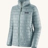 The front of the Patagonia women's nano puff jacket in thermal blue. A light blue jacket with rectangular puffer panels. Jacket features a full length zip and side pockets