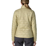 Back of woman wearing Patagonia's women's nano puff jacket weathered stone lightweight insulated jacket showing brick quilting 